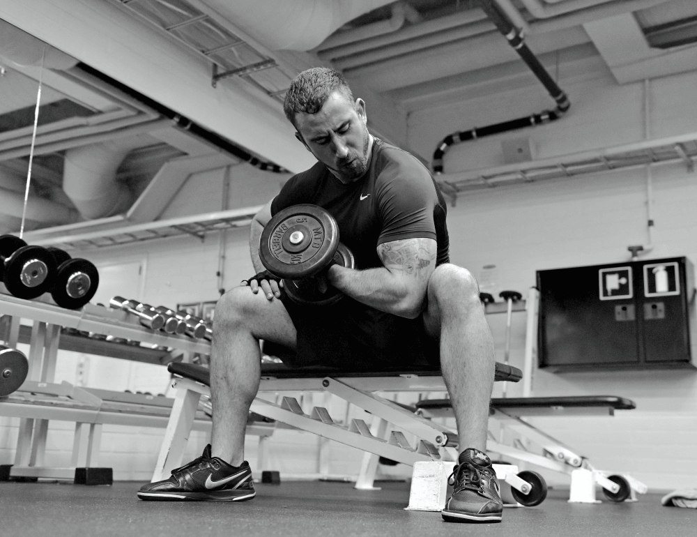 Doing seated bicep curls